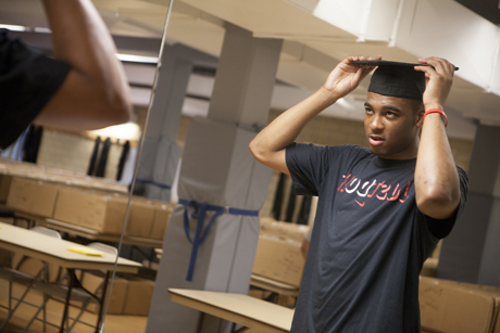 student tries on cap