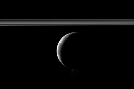 Enceladus appears with Saturn's rings