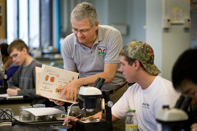 George Hudler works with students
