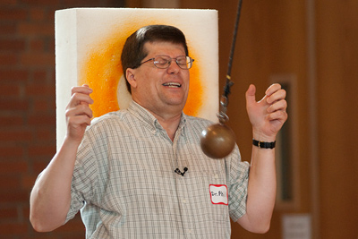 Phil Krasicky allows a pendulum to swing towards his face