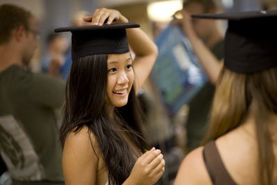 student tries on mortarboard