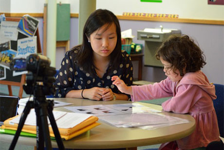 Wendy Wei leads a child through spatial cognition tests
