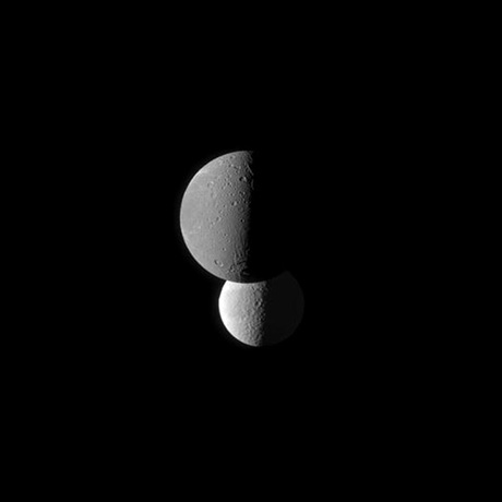 Saturn's moon Dione, foreground, appears darker than the moon Tethys because it has a lower surface albedo, as shown in a photograph taken from the Cassini spacecraft on March 23, 2010. At the time, Cassini was about 746,000 miles from Dione and about 1.1 million miles from Tethys.