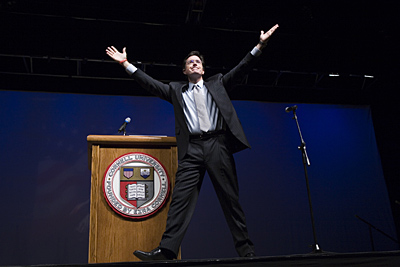 Stephen Colbert with arms raised