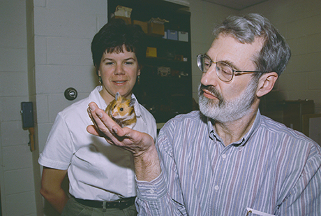 Jill Mateo and professor Robert Johnston with one of the golden hamster