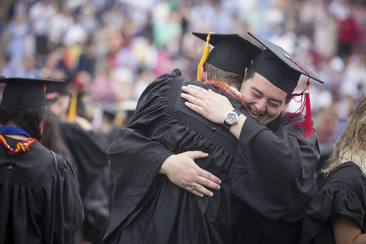 Graduates hug