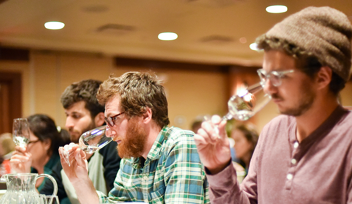 Vineyard owners smell wine