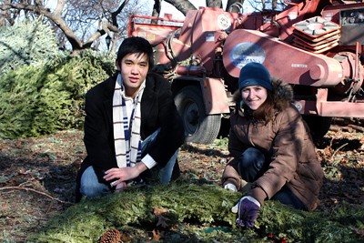Dennis Shen and Greta Kirchner dispose of Christmas trees