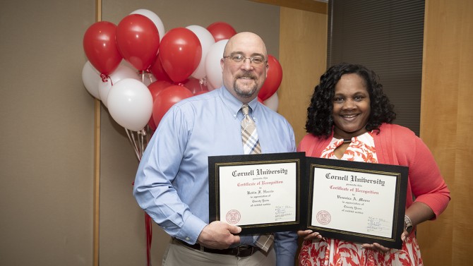 Kevin F. Harris and Veronica A. Moore  are recognized for 20 years of service.