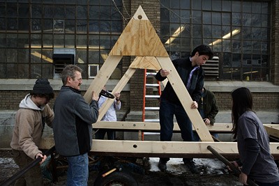 Architecture students working on a model of the 2008 dragon behind Rand Hall