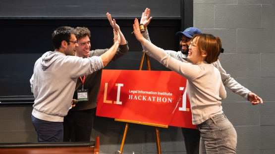 The winning team celebrates its victory during Cornell’s inaugural Legal Information Institute Hackathon in Myron Taylor Hall.