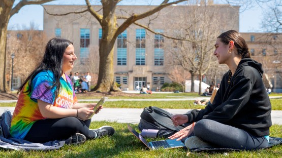 Friends hang out on the Ag Quad on a spring day.