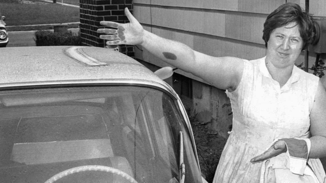A Baltimore woman wipes soot from the roof of her car in a photo dated July 8, 1967.