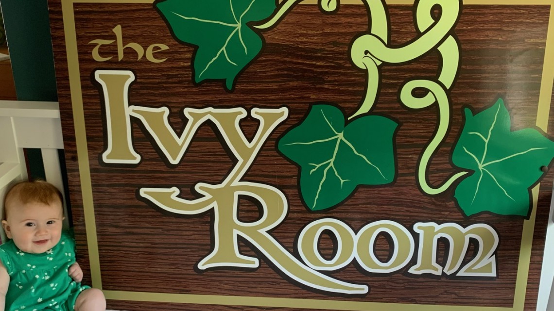 Ivy Goodwin with the Ivy Room sign