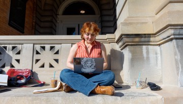 A student studies outside Sibley Hall during February break.