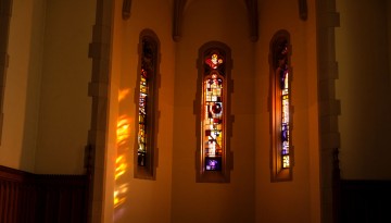 Stained-glass windows are illuminated in Anabel Taylor Hall.