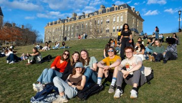 Students hang out on Libe Slope on a warm winter day.