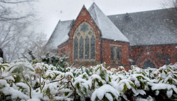 A spring snow squall covers plants in snow near Sage Chapel.