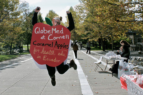 student selling caramel apples