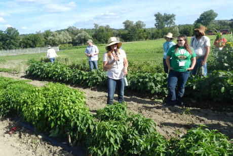 symposium participants tour farm