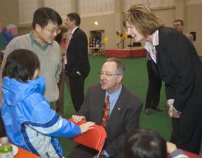 Robin Davisson and David Skorton greet staff