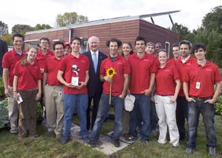 Cornell team in front of the house