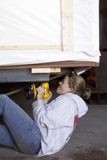 student Larissa Kaplan helps secure the solar house