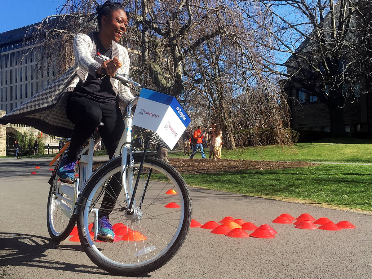 Student riding Big Red bike